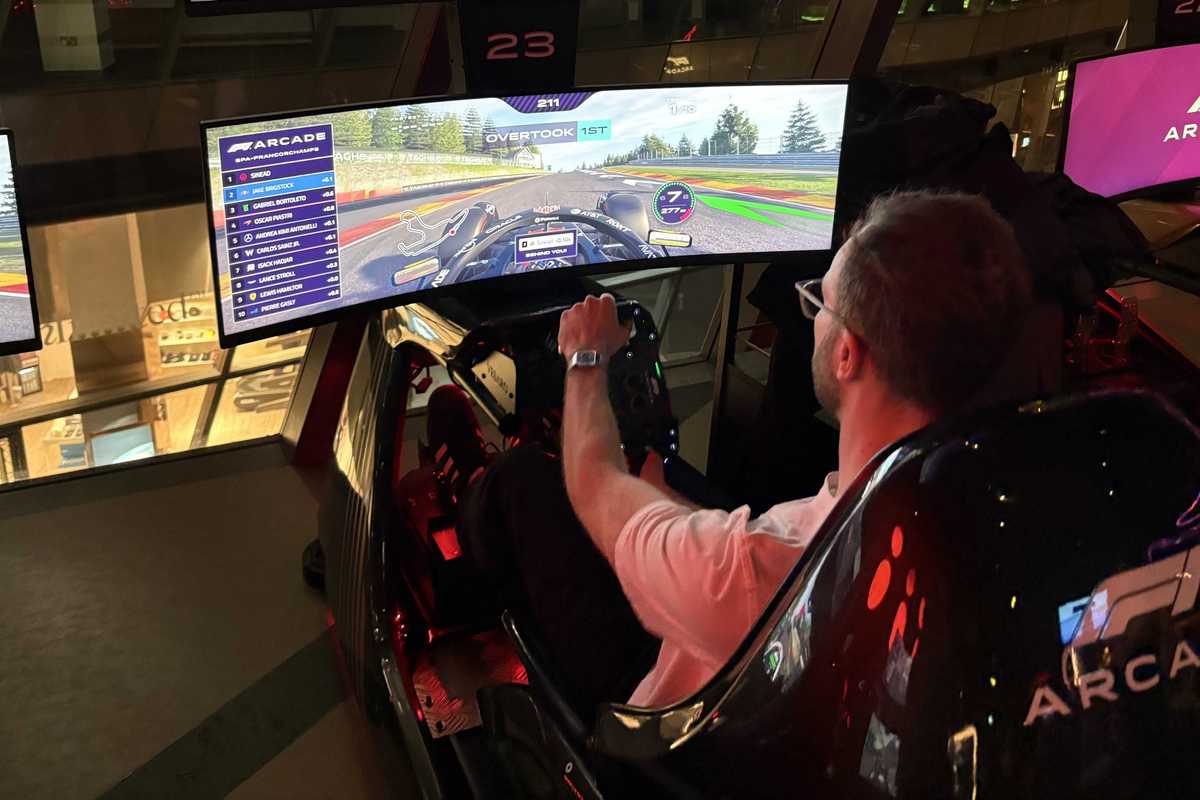 An image of Jake Brigstock playing on the racing sims at F1 Arcade in London