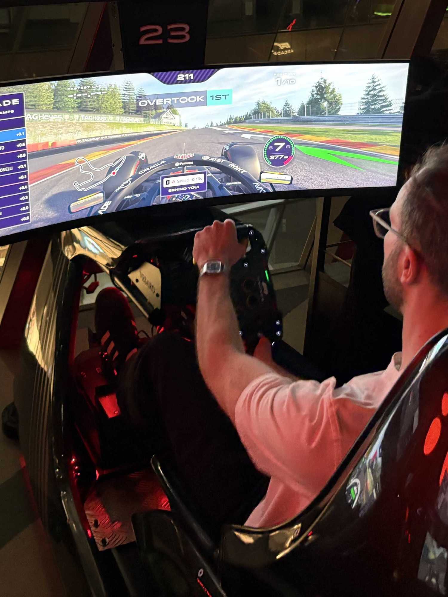 An image of Jake Brigstock playing on the racing sims at F1 Arcade in London