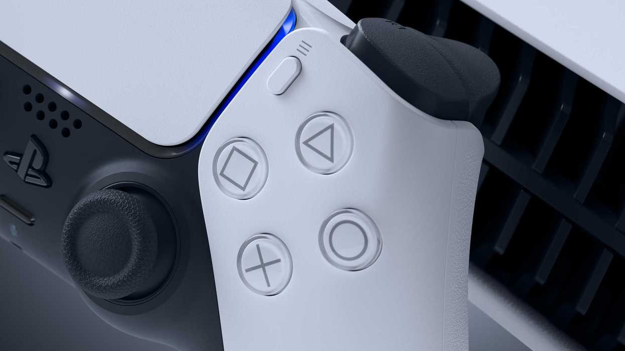 An official product image of the PlayStation DualSense wireless controller with a PS5 console in the background