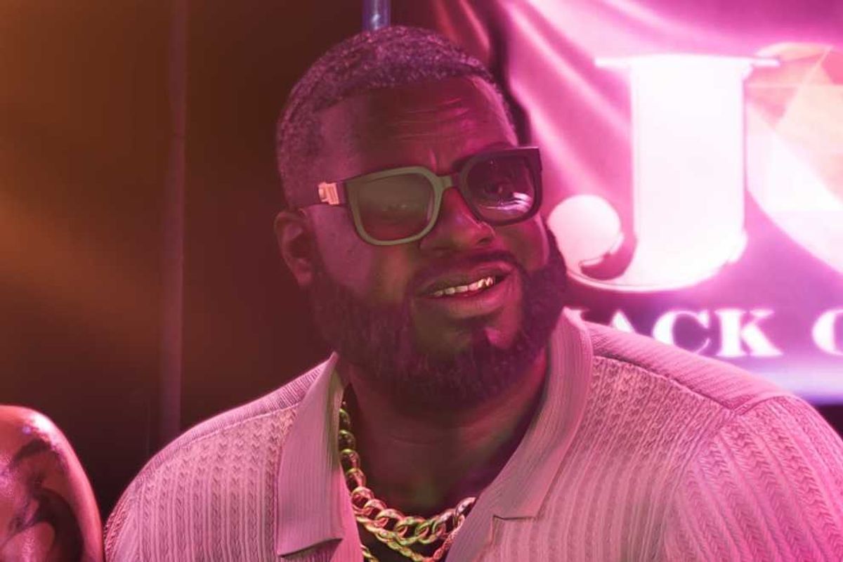 An official screenshot of Boobie Ike in a strip club in GTA 6