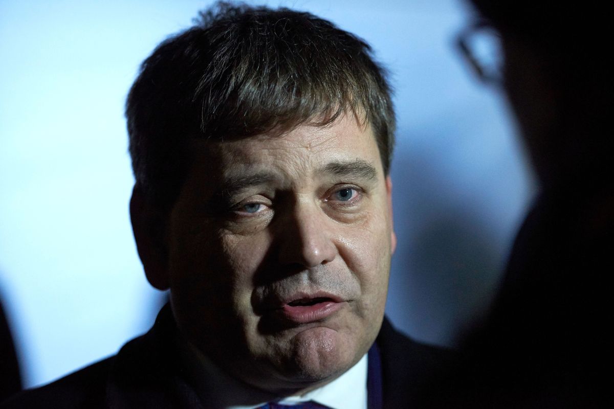 Andrew Bridgen, a white man with short black hair and a black suit.