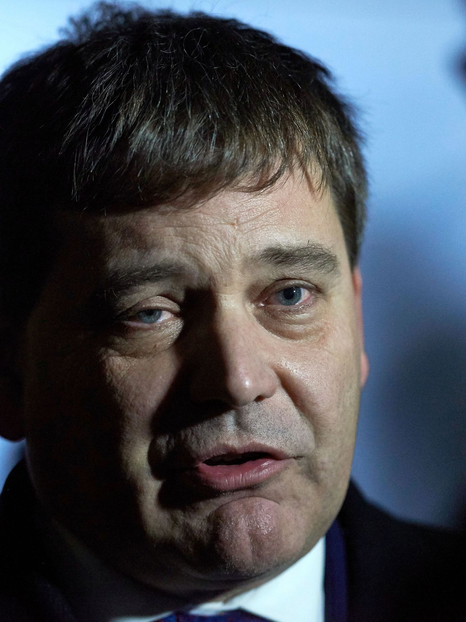 Andrew Bridgen, a white man with short black hair and a black suit.