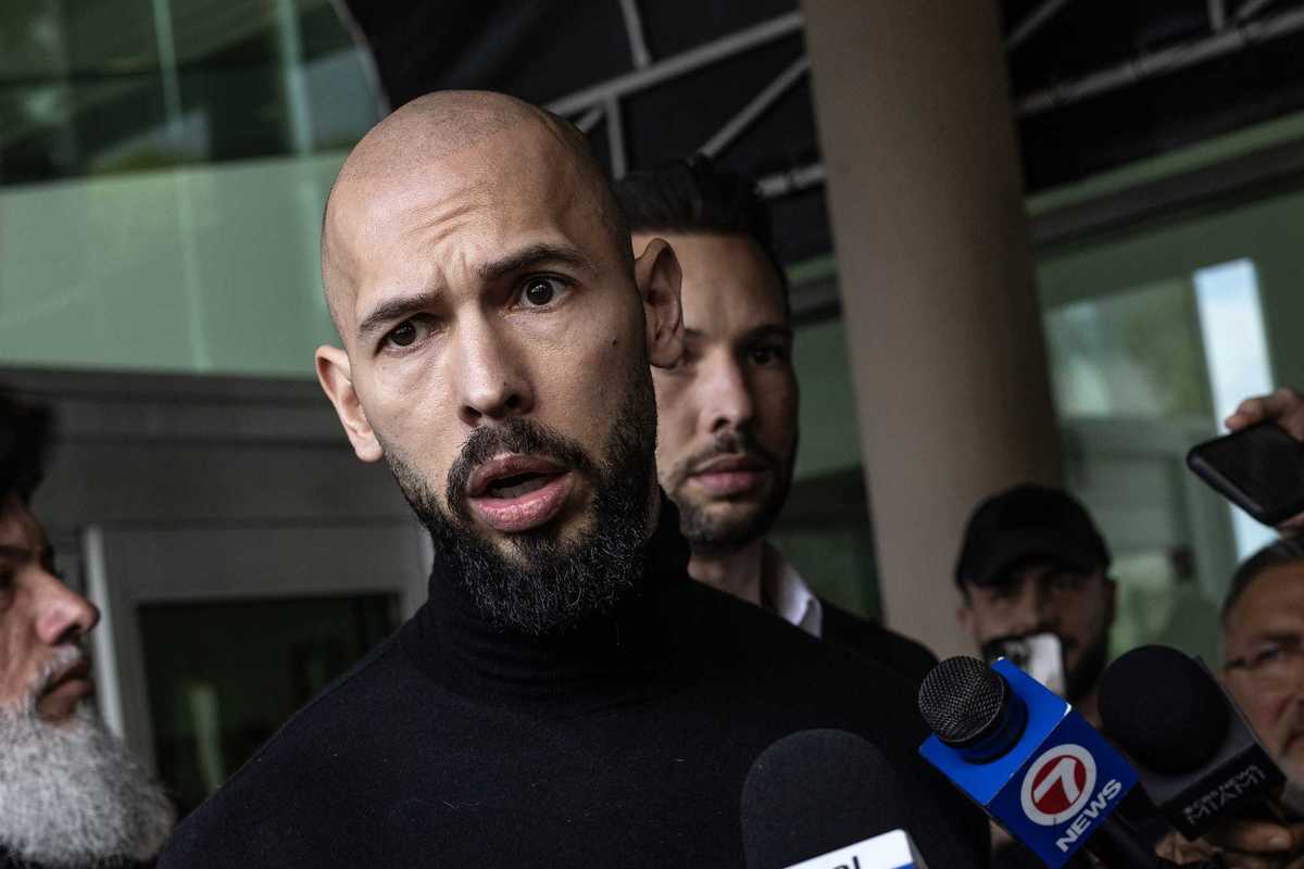 Andrew Tate, a bearded, bald white man.