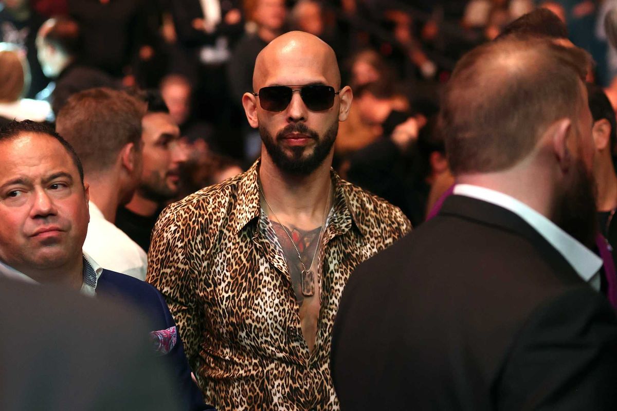Andrew Tate in sunglasses and a leopard-print shirt at a UFC event.
