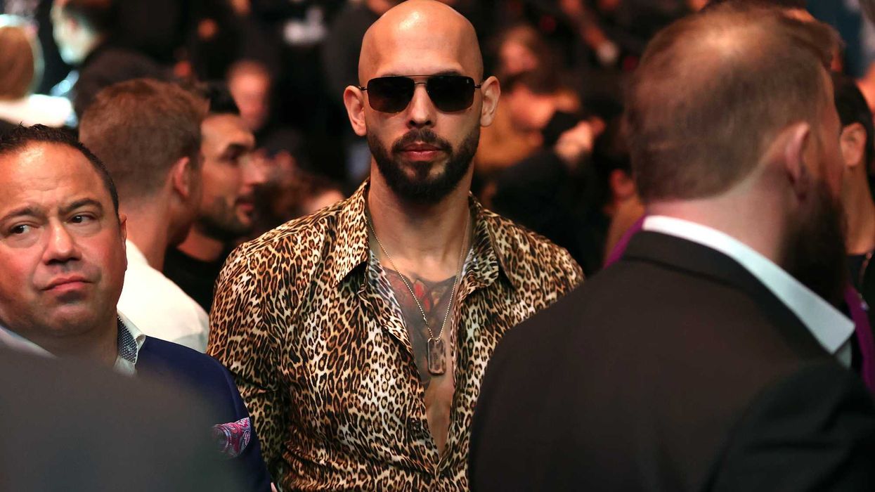 Andrew Tate in sunglasses and a leopard-print shirt at a UFC event.