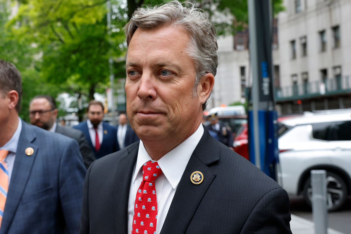 Andy Ogles, a white man with short grey hair, a black suit and patterned red tie.