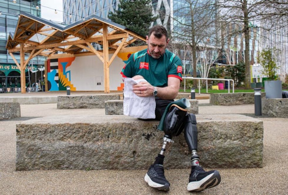 Andy Reid adjusting one of his prosthetics