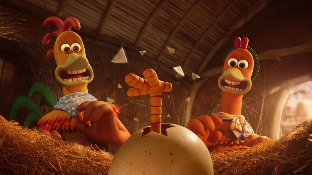 Animation still from Chicken Run 2, showing a foot emerging from a cracked egg and two chickens (Ginger and Rocky) bending back in surprise.