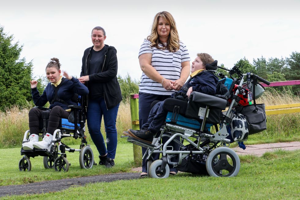 Anne Kelly with her daughter Erin, 13 (left) and Donna Quinn with her son Logan (Robert Perry/PA)