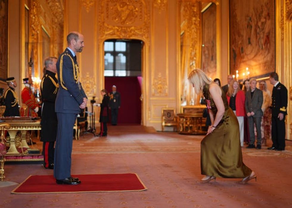 Anne-Marie Duff performs a curtsy before the Prince of Wales at Windsor Castle