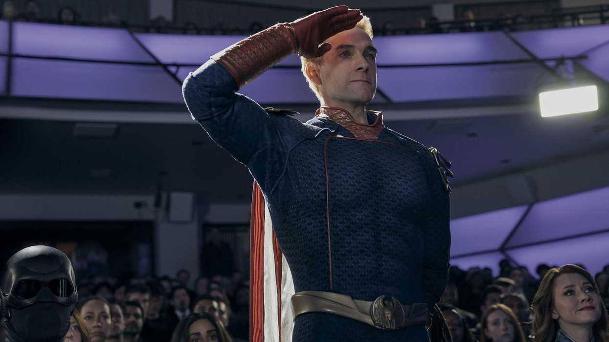 Antony Starr as Homelander in The Boys, standing and saluting something off-camera.