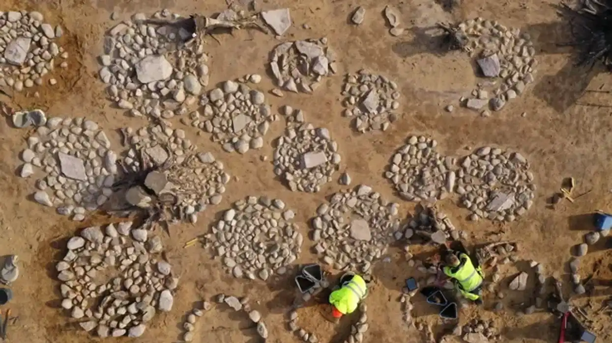 Archeaologists work at the 2,500-year-old site of some 40 graves, mostly of children