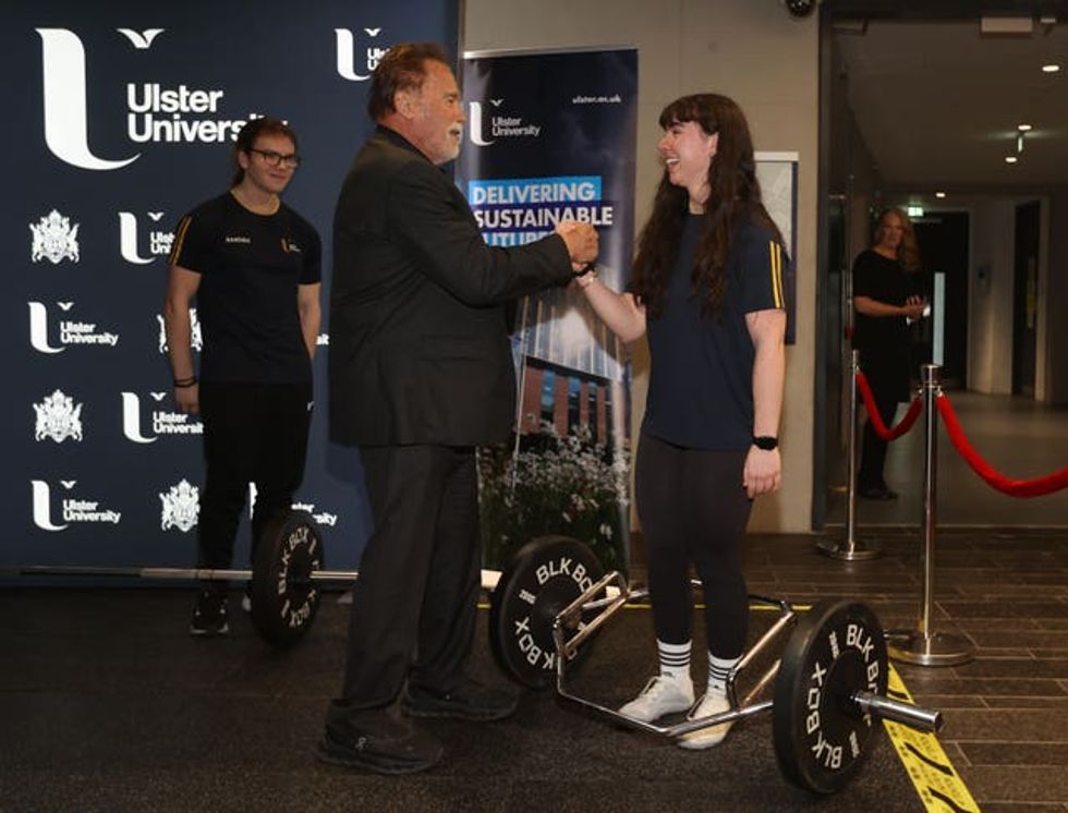 Arnold Schwarzenegger talks to pharmacy student Minnie Dihmis as he arrives at Ulster University in Belfast ahead of being presented with an honorary doctorate