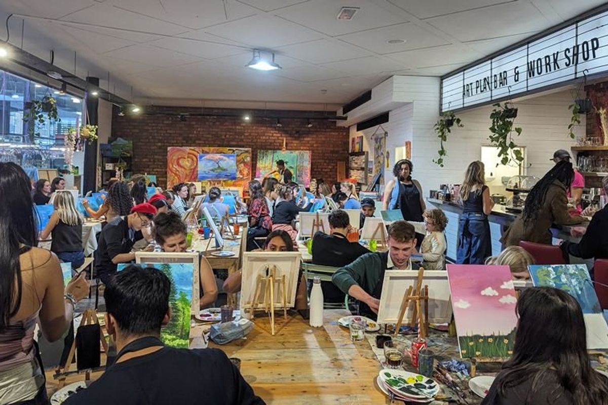 Art lovers paint on canvases in an art classroom