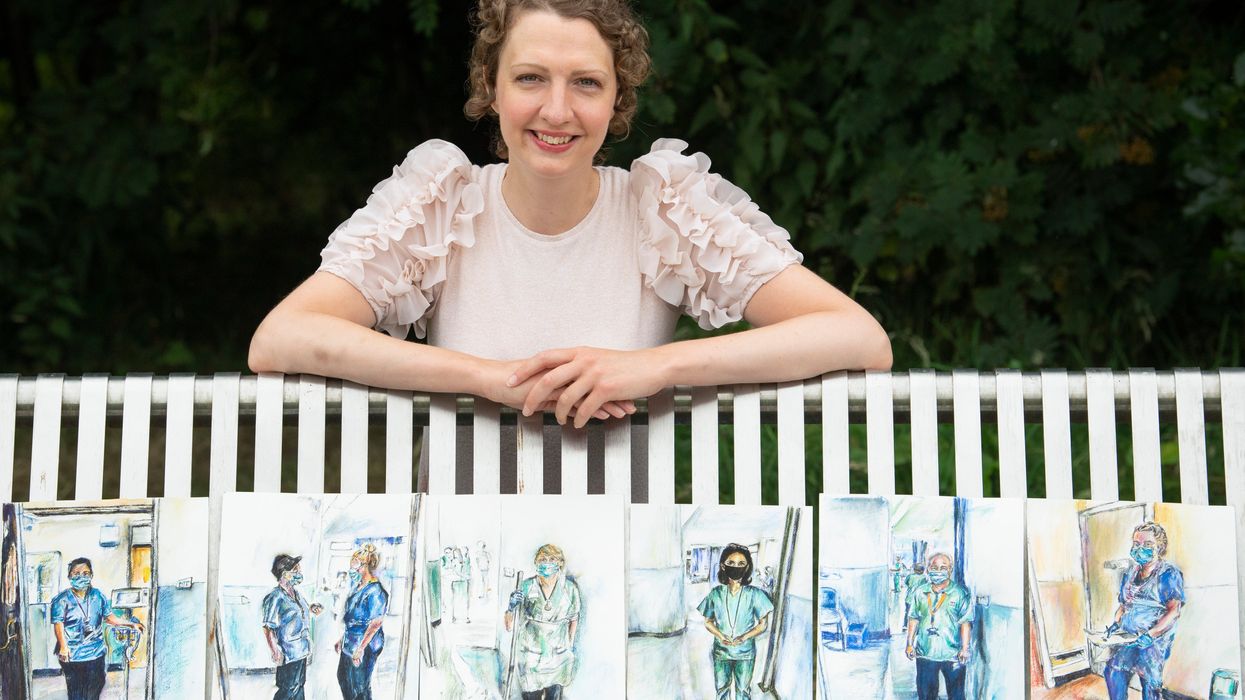 Artist Gillian McLaren with her portraits (Lesley Martin/PA)
