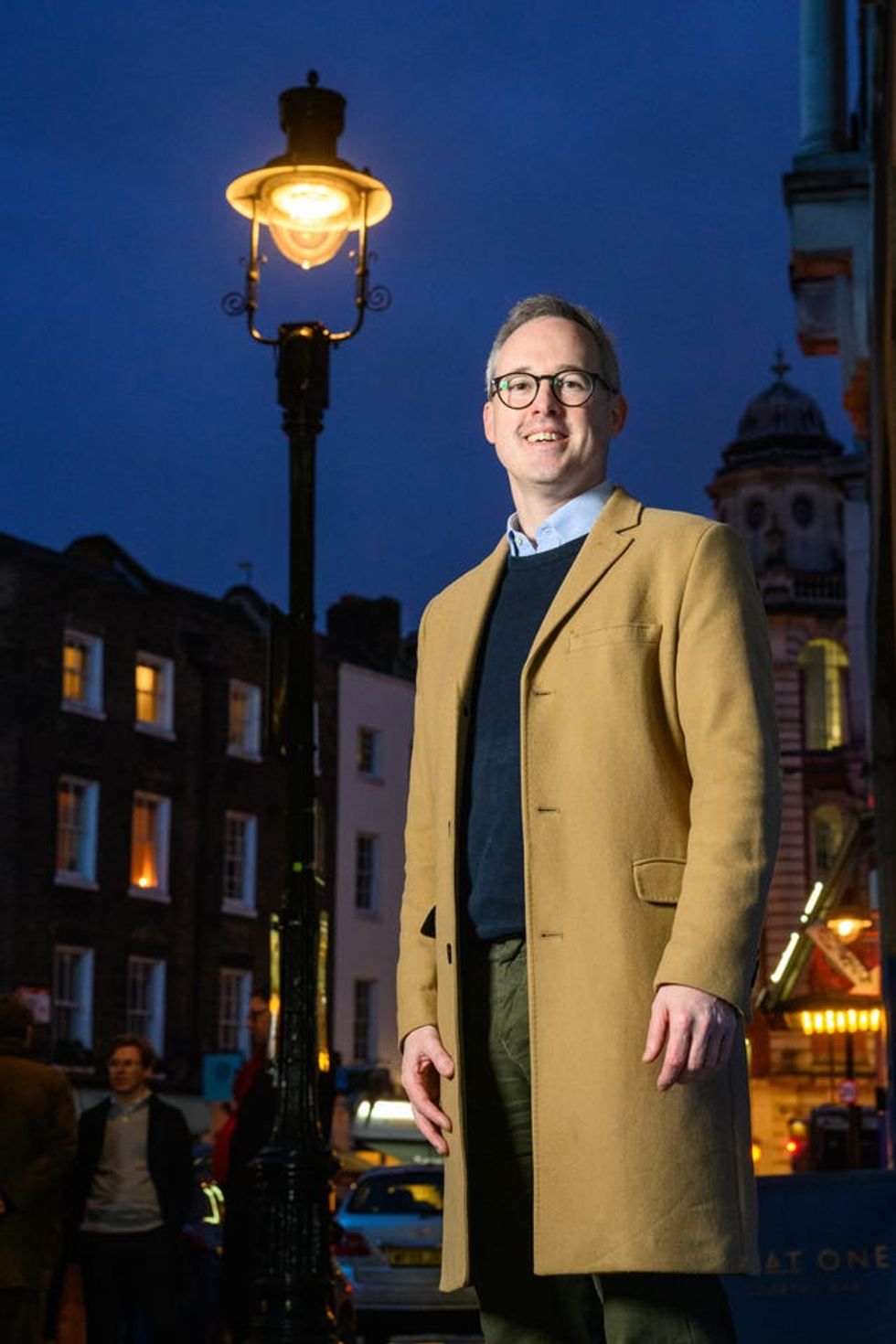 Arts and Heritage minister Lord Parkinson stands under one of four gas lamps along Russell Street in Covent Garden, London that have today been given Grade II listing protection.