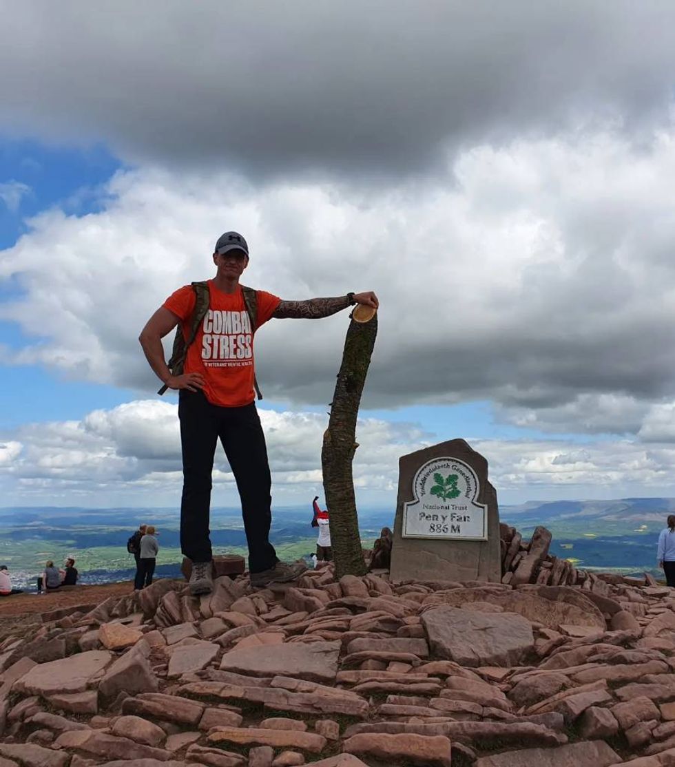 At the top of Pen y Fan, Roberson carrying a log he initially used to train with. (Handout/PA)