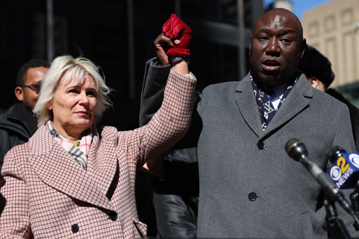 Attorney Ben Crump raises his hand with former music executive Dorothy Carvello in announcing a sexual assault lawsuit against Atlantic Records Chairman Ahmet Ertegun and numerous male executives at Atlantic Records, on March 08, 2023 in New York City.
