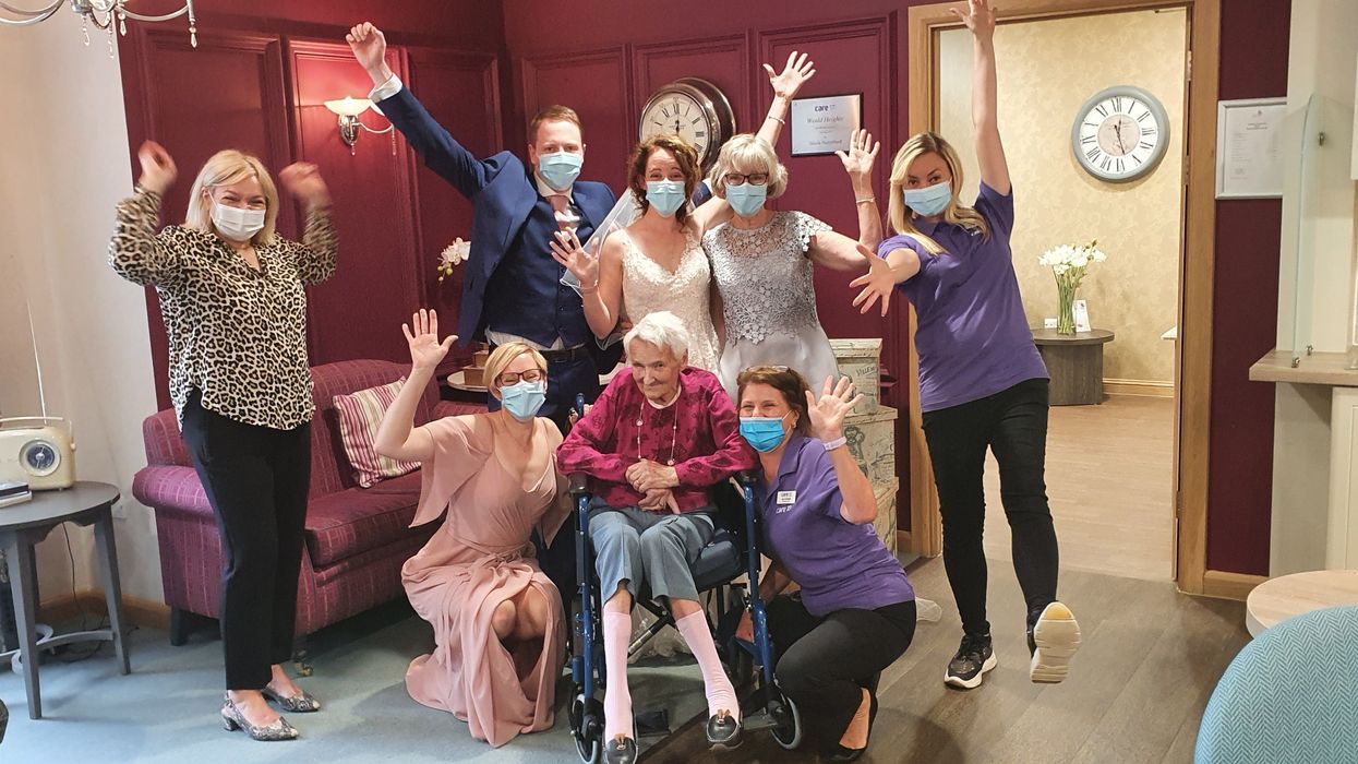 Audrey Dear with her granddaughter Holly Kennedy, grandson-in-law Steve Kennedy, other family members and care home staff (Weald Heights/PA)