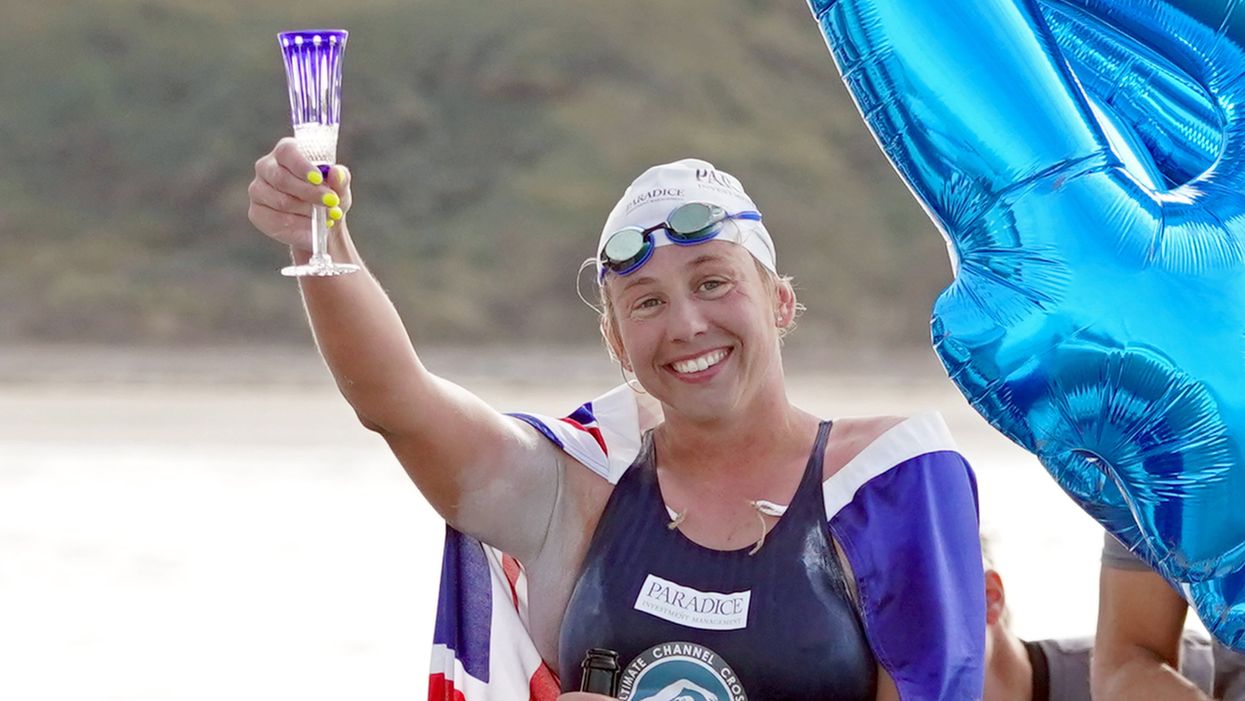 Australian endurance swimmer Chloe McCardel raises as glass after completing her 44th swim across the English Channel (Gareth Fuller/PA)