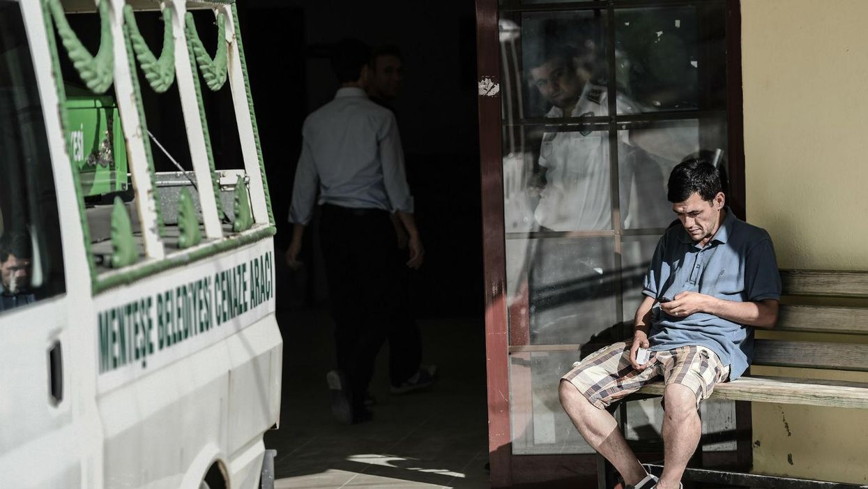 Aylan's father Abdullah al-Kurdi waits outside a morgue in Turkey for his son's bodies