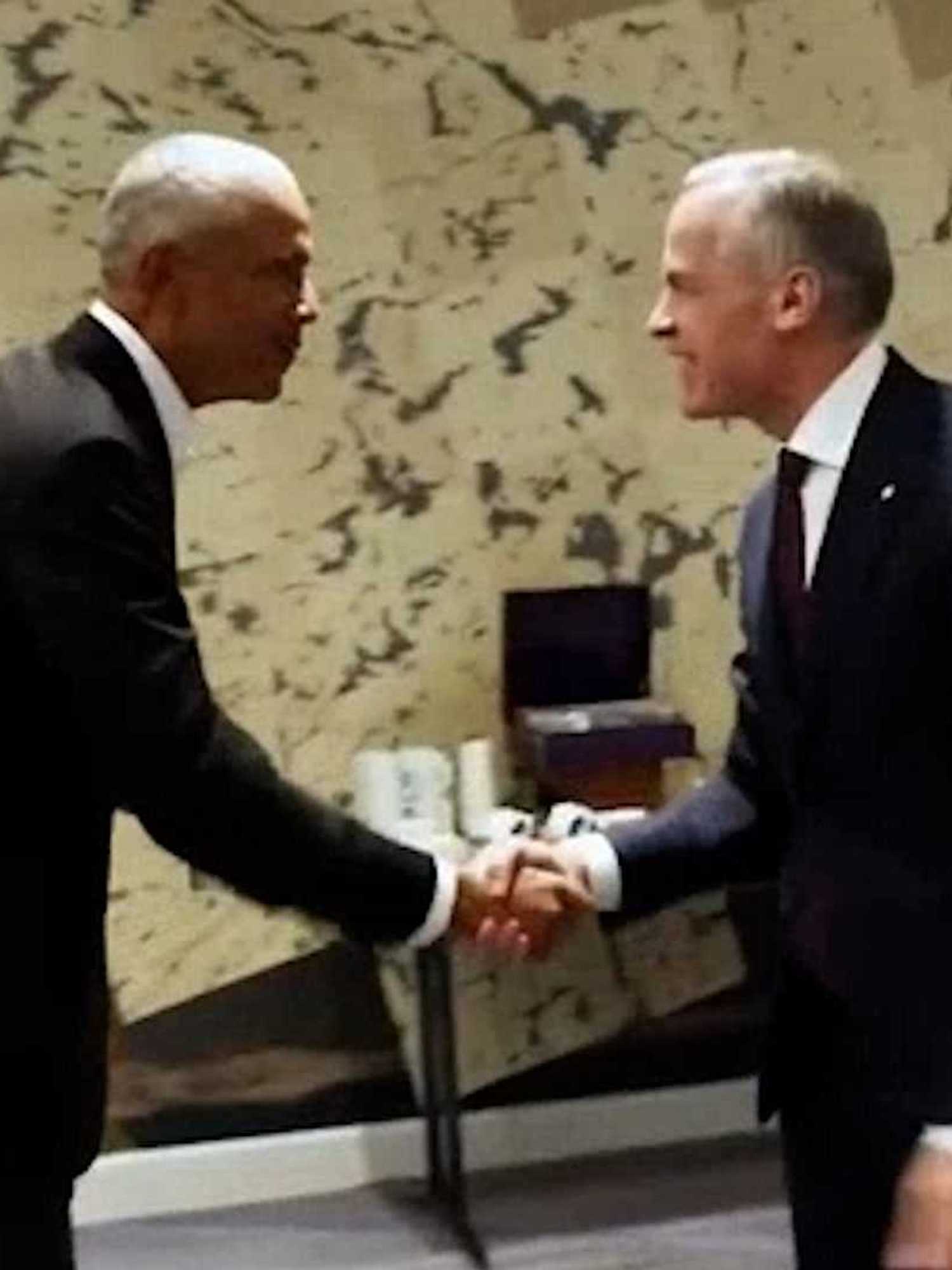 Barack Obama, left, shakes hands with Mark Carney, right.