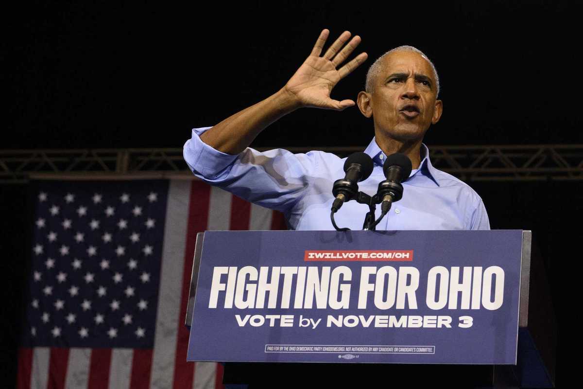 Barack Obama speaking behind a lectern with the words 'Fighting for Ohio. Vote by November 3' on it.