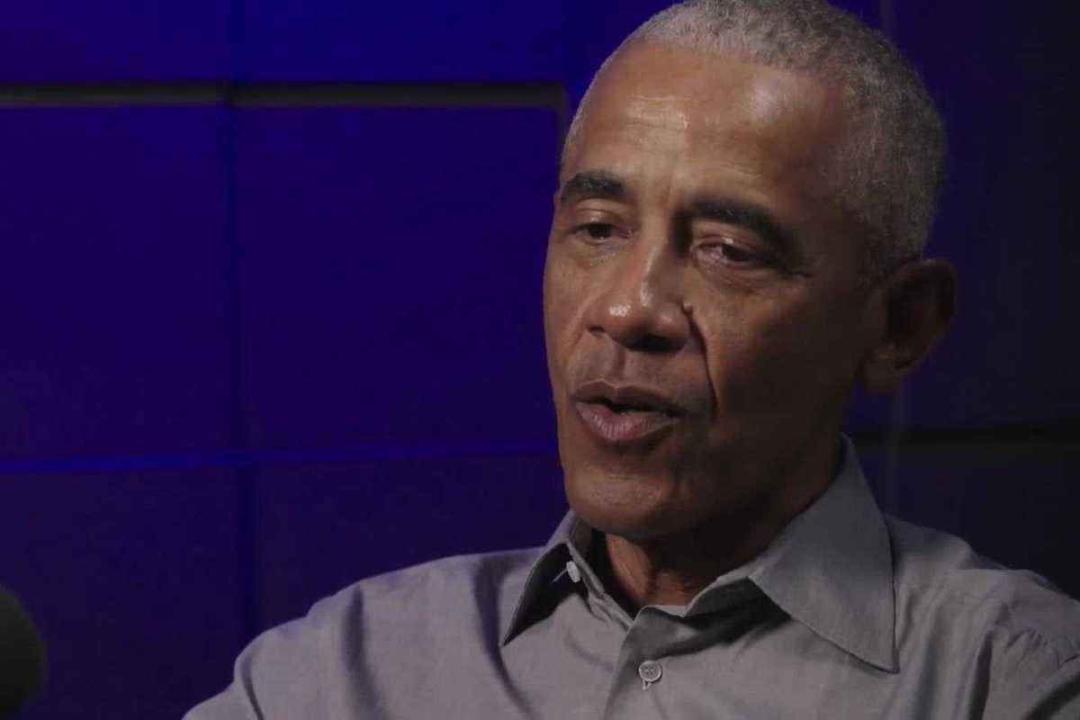 Barack Obama speaking in a podcast studio.