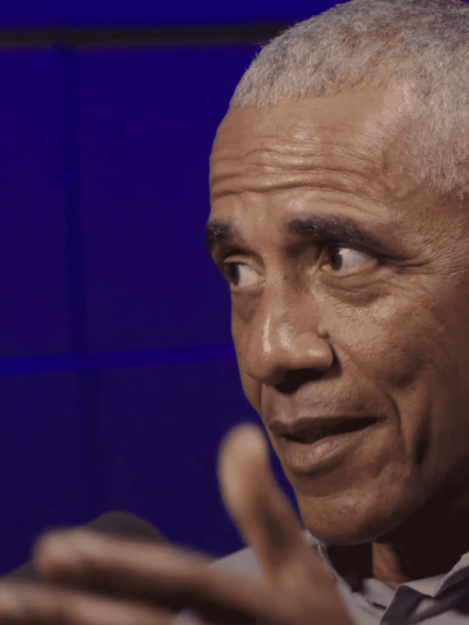 Barack Obama speaking in a podcast studio.