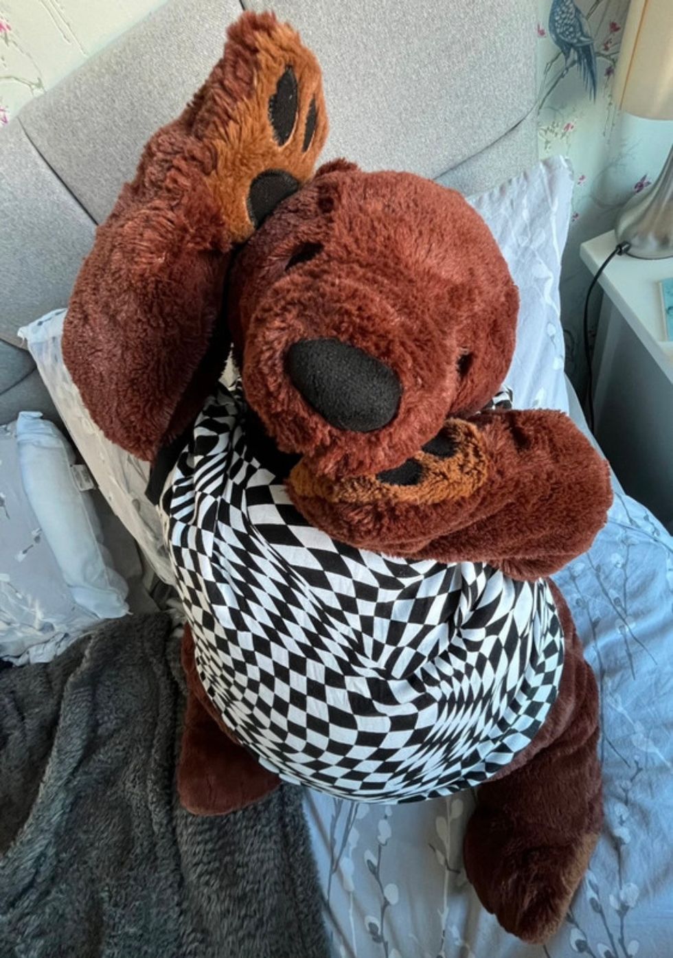 Bear posing with hands on face