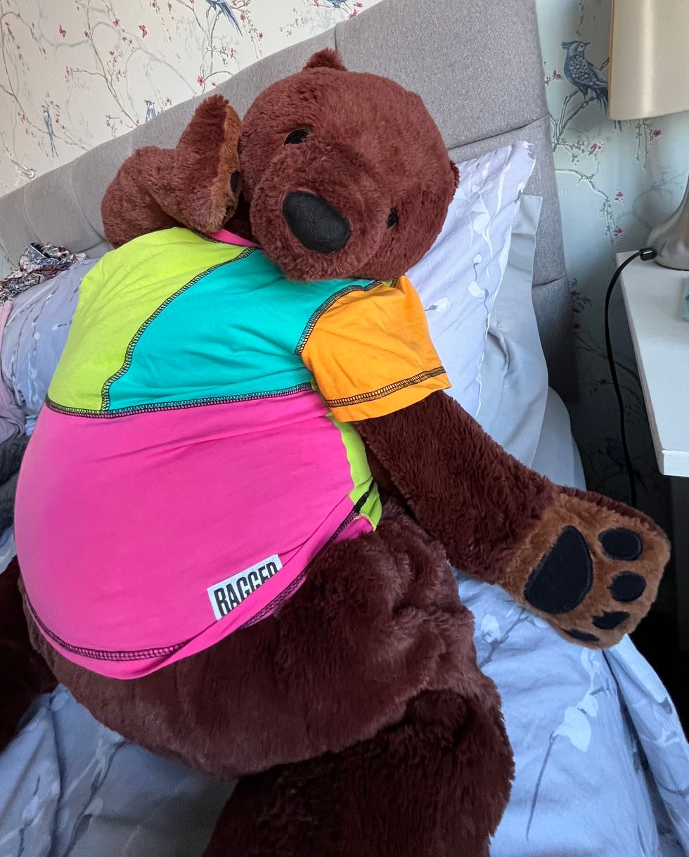 Bear toy posing on bed