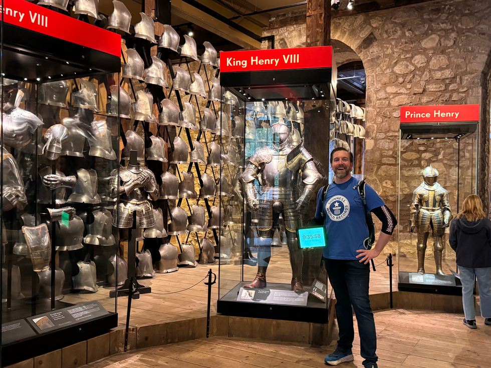 Ben Melham in front of a display showing suits of armour