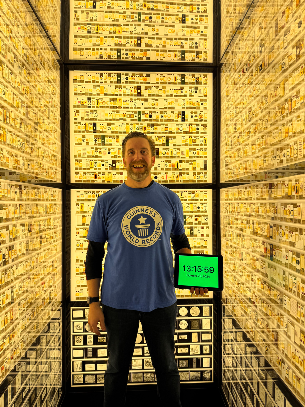 Ben Melham smiling while inside a museum exhibit