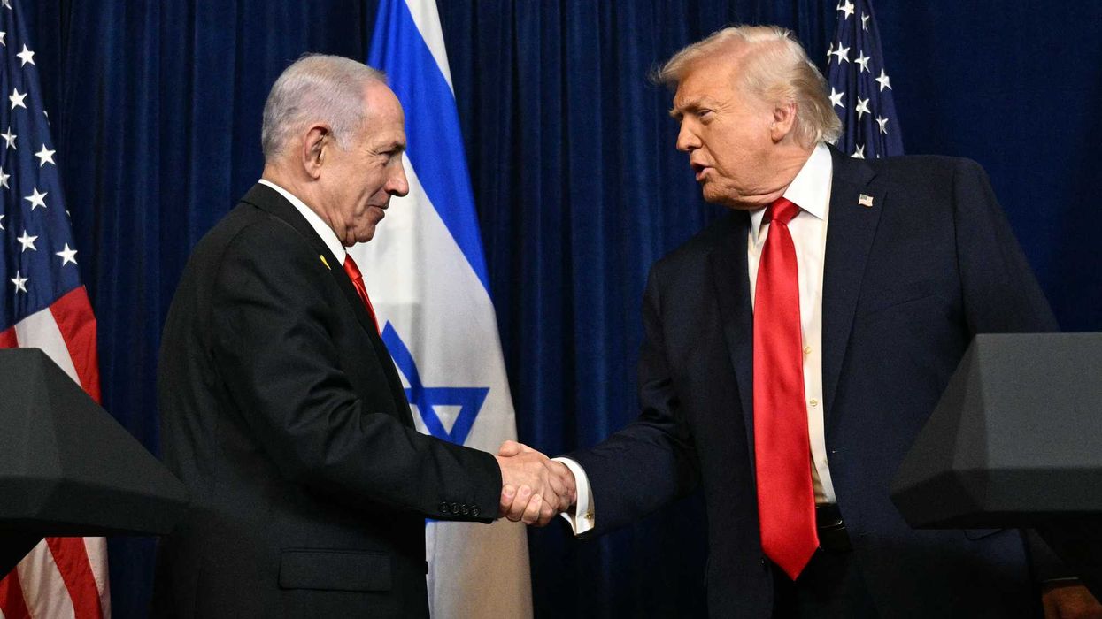 Benjamin Netanyahu, left, shakes hands with Donald Trump, right.