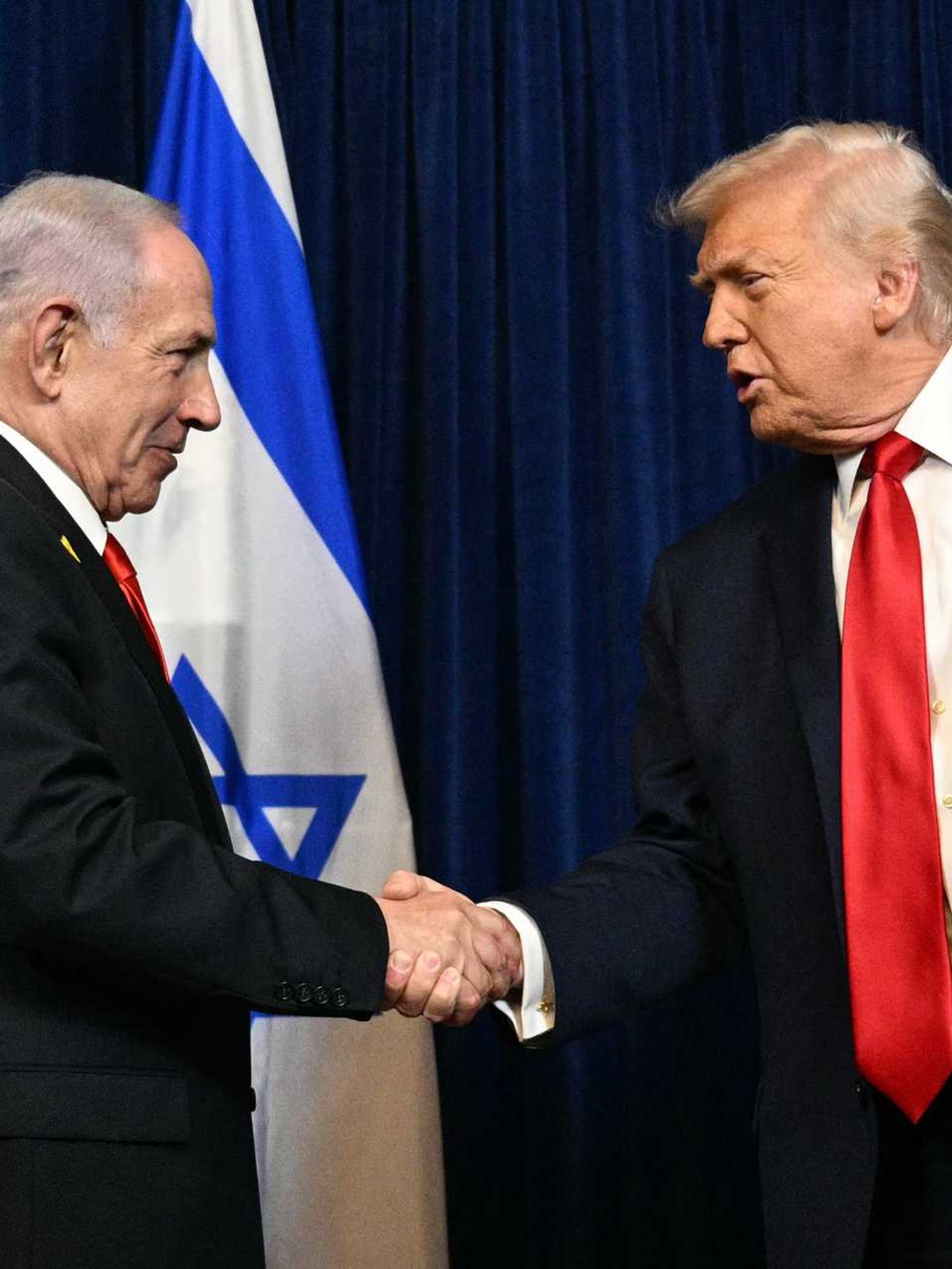 Benjamin Netanyahu, left, shakes hands with Donald Trump, right.