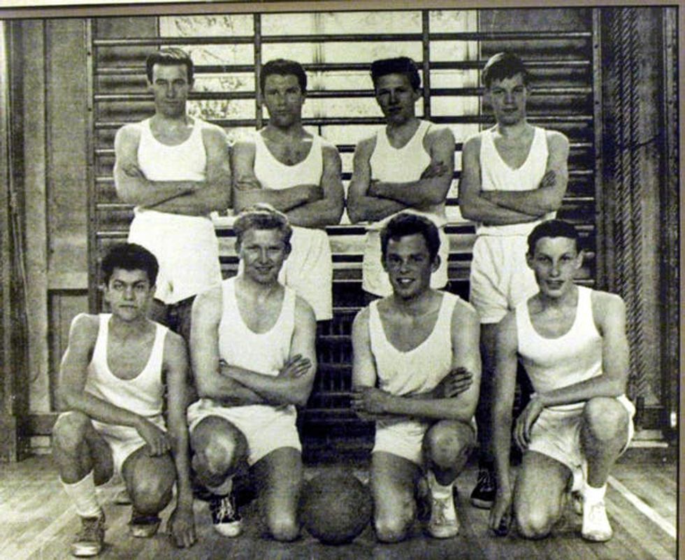Black and white image of Mick Jagger (back row, far right) in the school basketball team at Dartford Grammar School, Kent, which he left in 1961