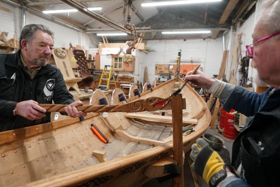 Bob Marshall (right) and Colin Laycock working on the replica Viking longboat