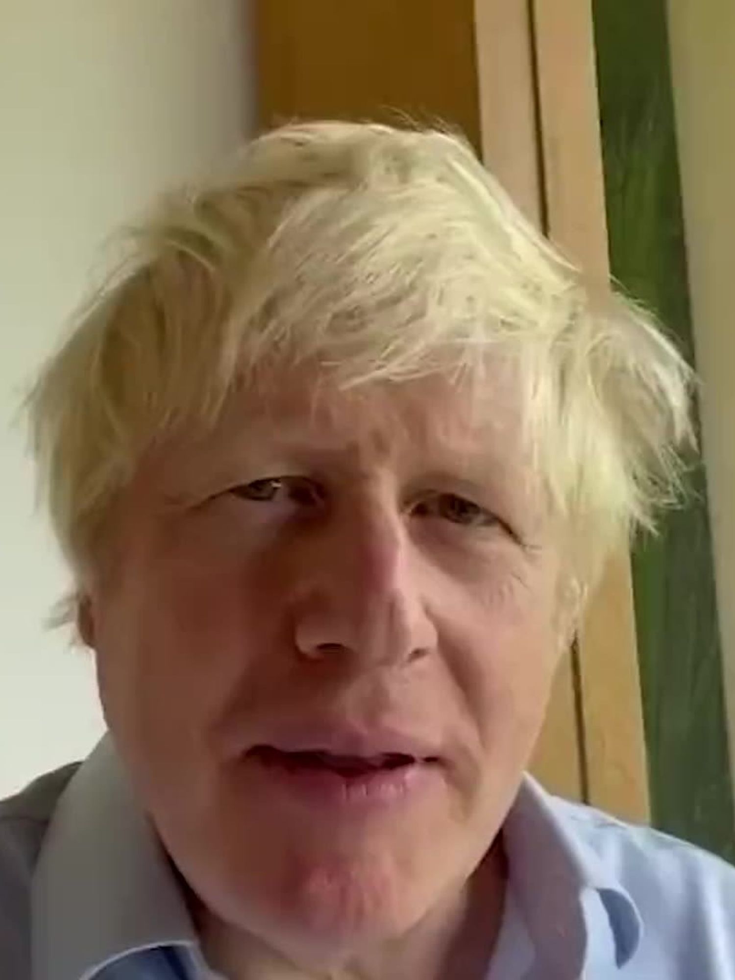 Boris Johnson, a white man with scruffy blonde hair, speaks into the camera.
