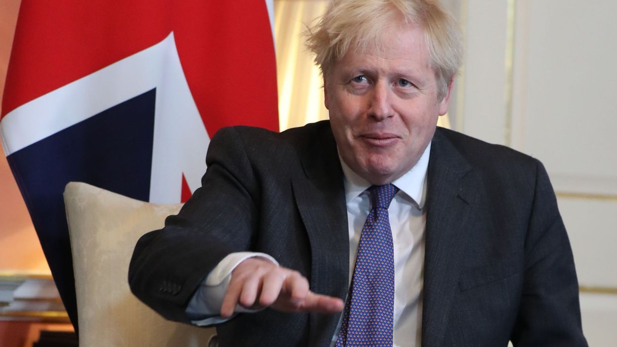 Boris Johnson sits in front of a Union flag inside 10 Downing Street