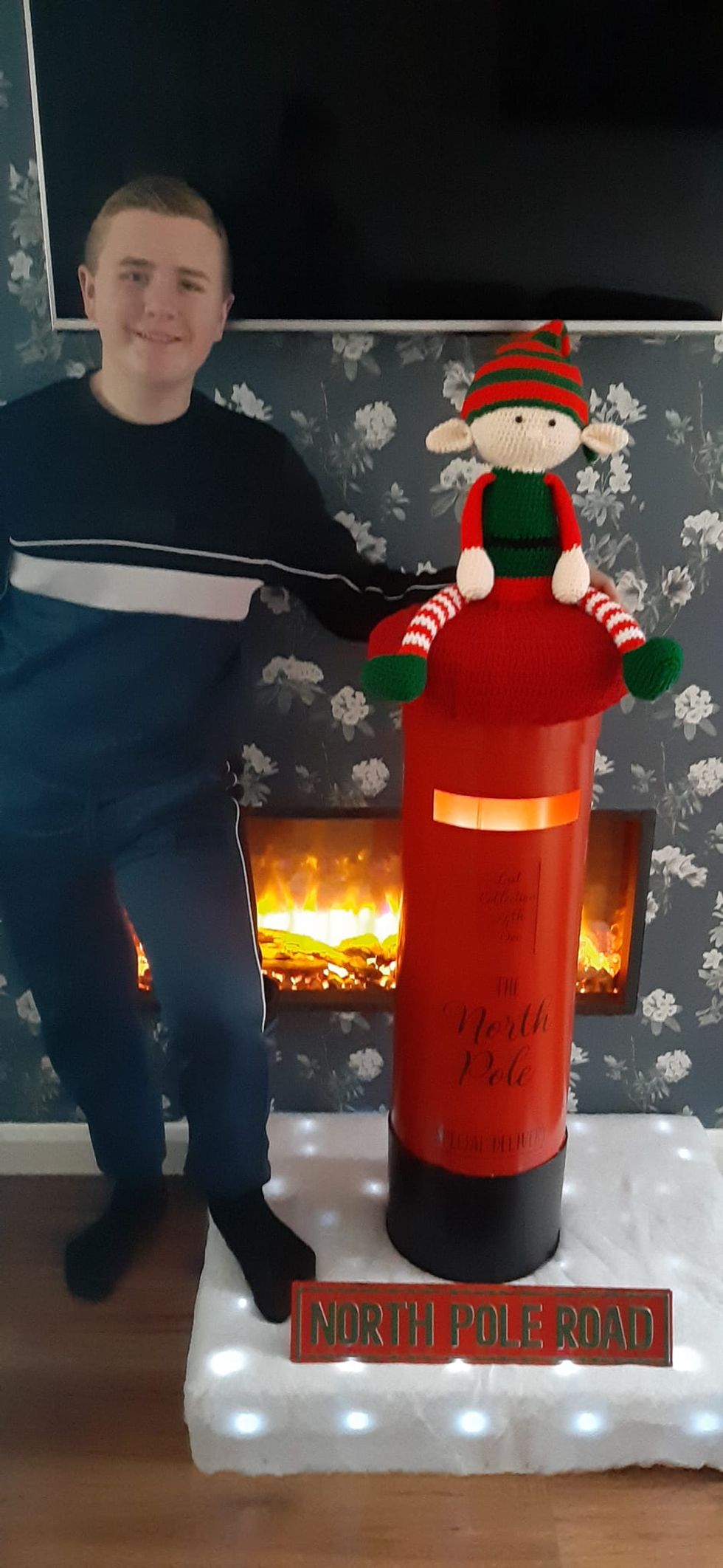 Boy standing next to postbox