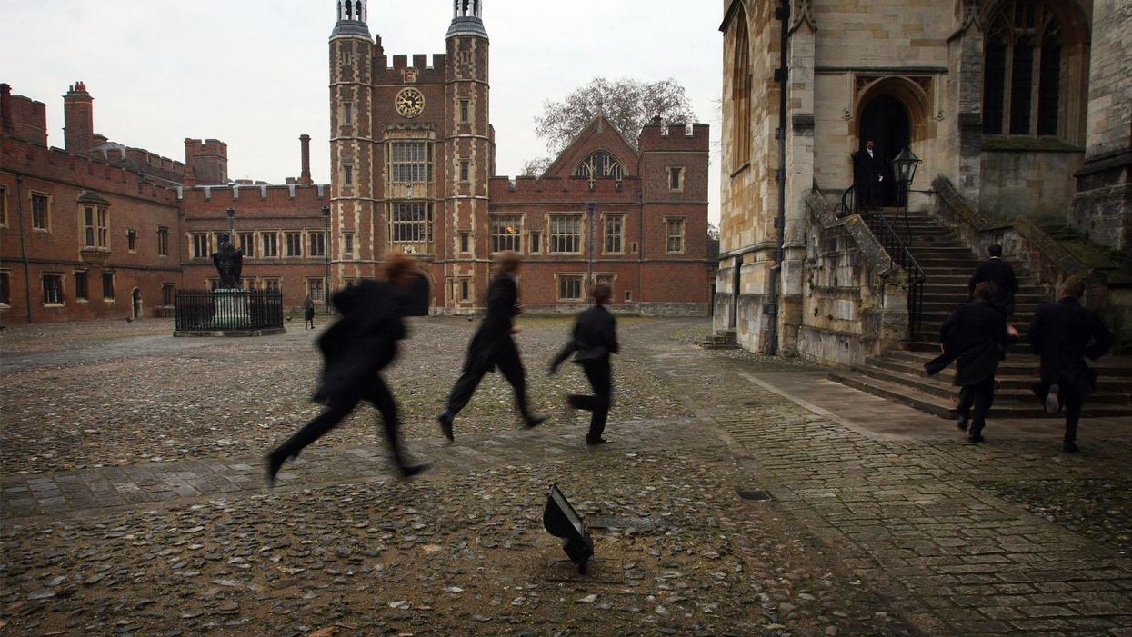 Boys run across the school yard of Eton College