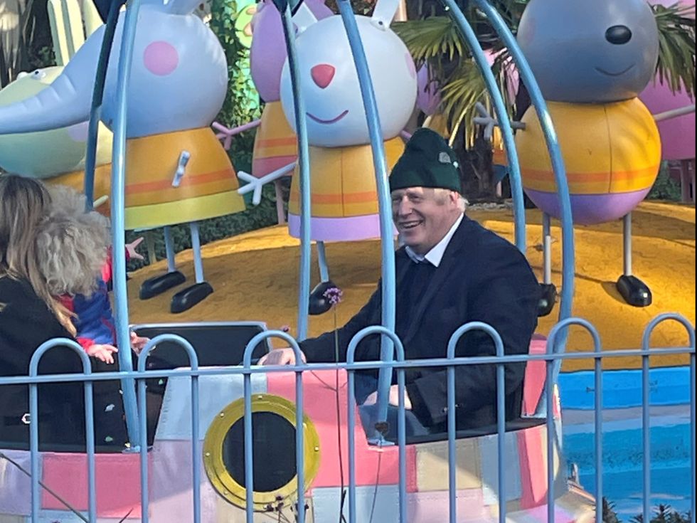 Britain's Prime Minister Boris Johnson enjoys a ride with his wife Carrie Johnson and son at Peppa Pig World near Ower
