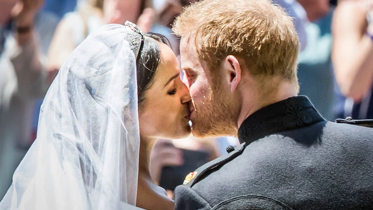 Britain's Prince Harry, Duke of Sussex kisses his wife Meghan, Duchess of Sussex 