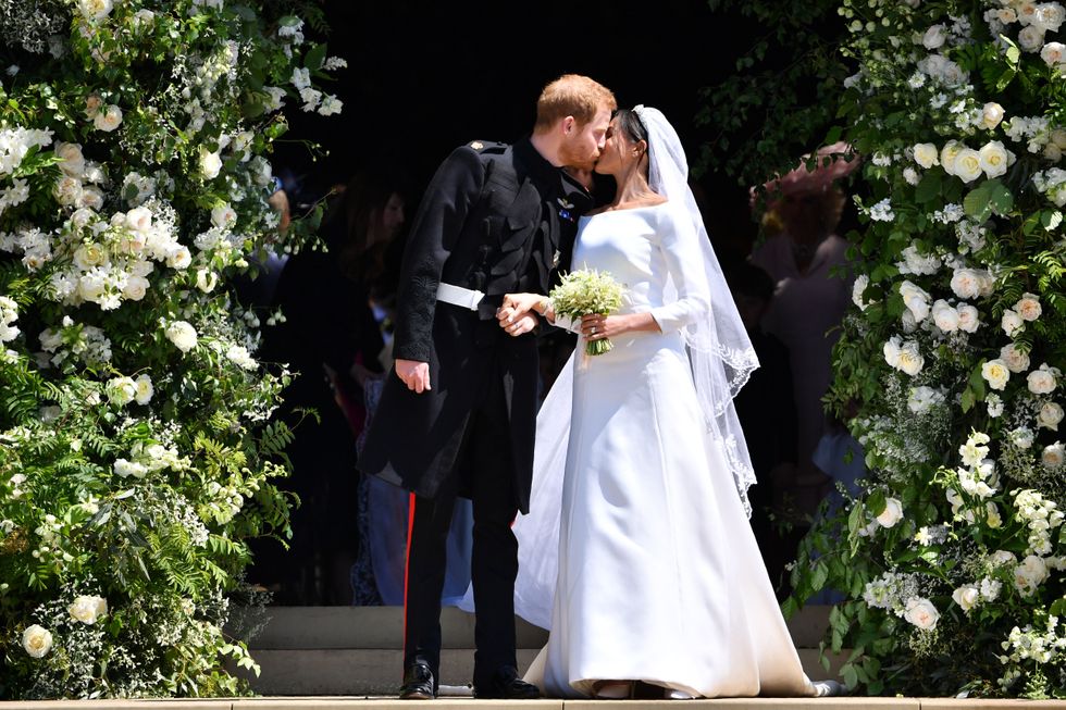 Britain's Prince Harry, Duke of Sussex kisses his wife Meghan, Duchess of Sussex 