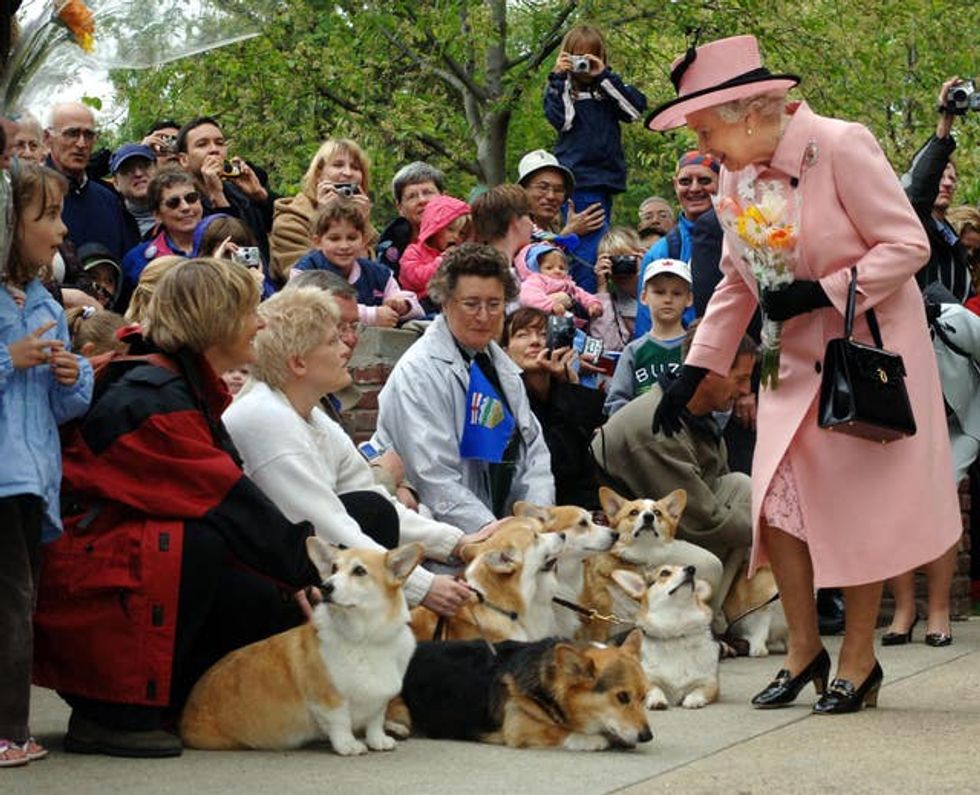 Britain\u2019s Queen Elizabeth II is greeted by local corgi enthusiasts as she departs the Legislature Building