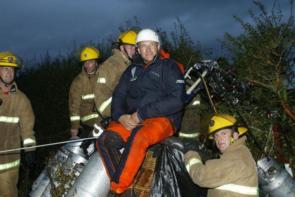 British adventurer David Hempleman-Adams on top of his balloon\u2019s basket after landing safely in Britain after becoming the first person to cross the Atlantic solo in an open wicker basket balloon in 2003