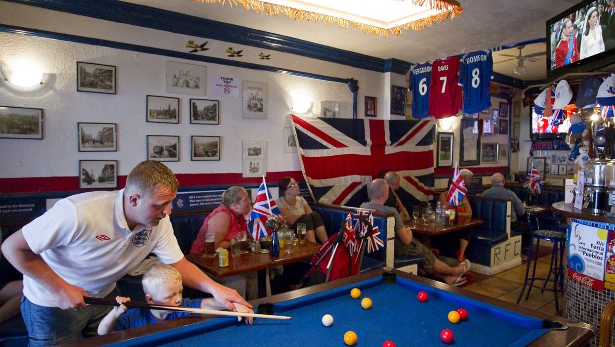 British expats play pool and watch the royal wedding between Prince William and Catherine on TV at British pub... in Benalmadena, Spain