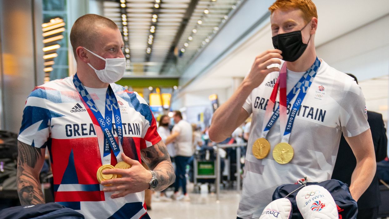 British swimmers Adam Peaty (left) and Tom Dean arrive back at London Heathrow Airport (Aaron Chown/PA)