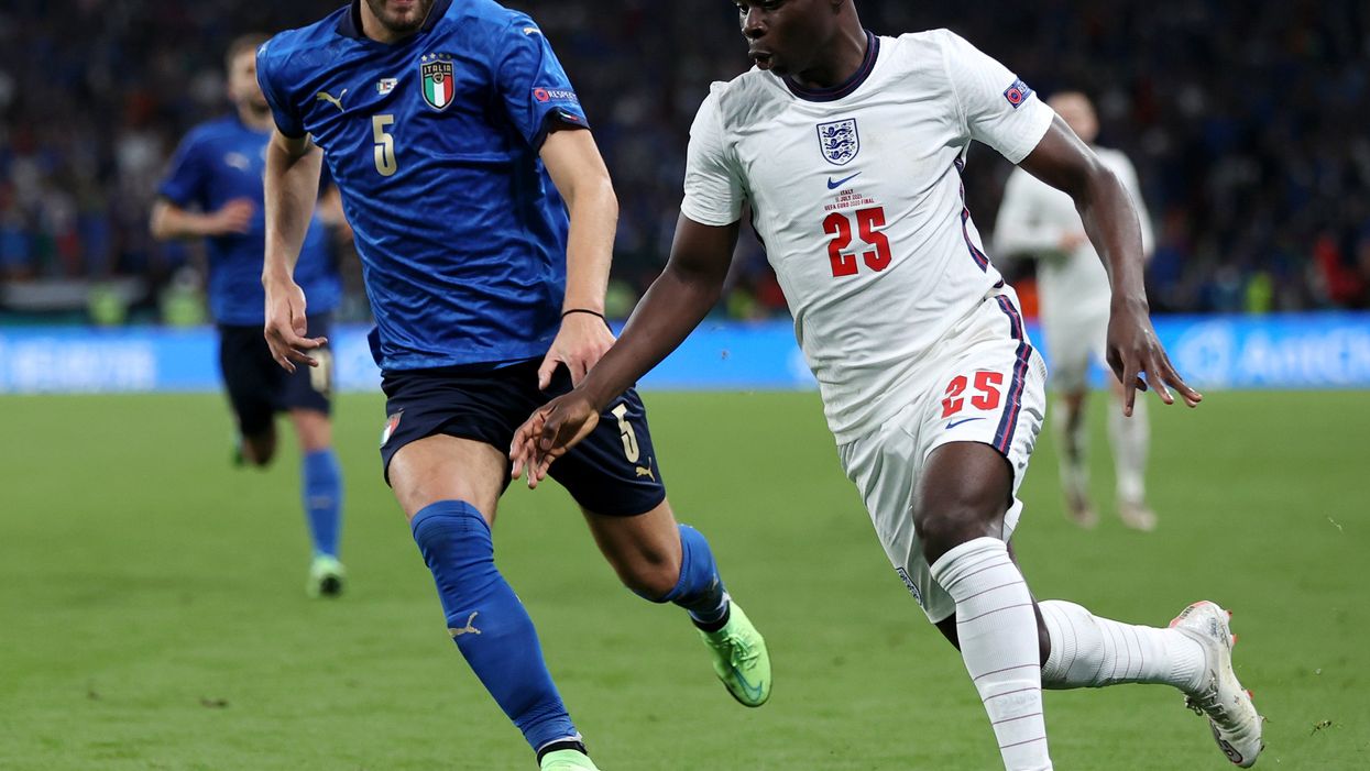<p>Bukayo Saka of England battles for possession with Manuel Locatelli of Italy during the Euro 2020 final</p>