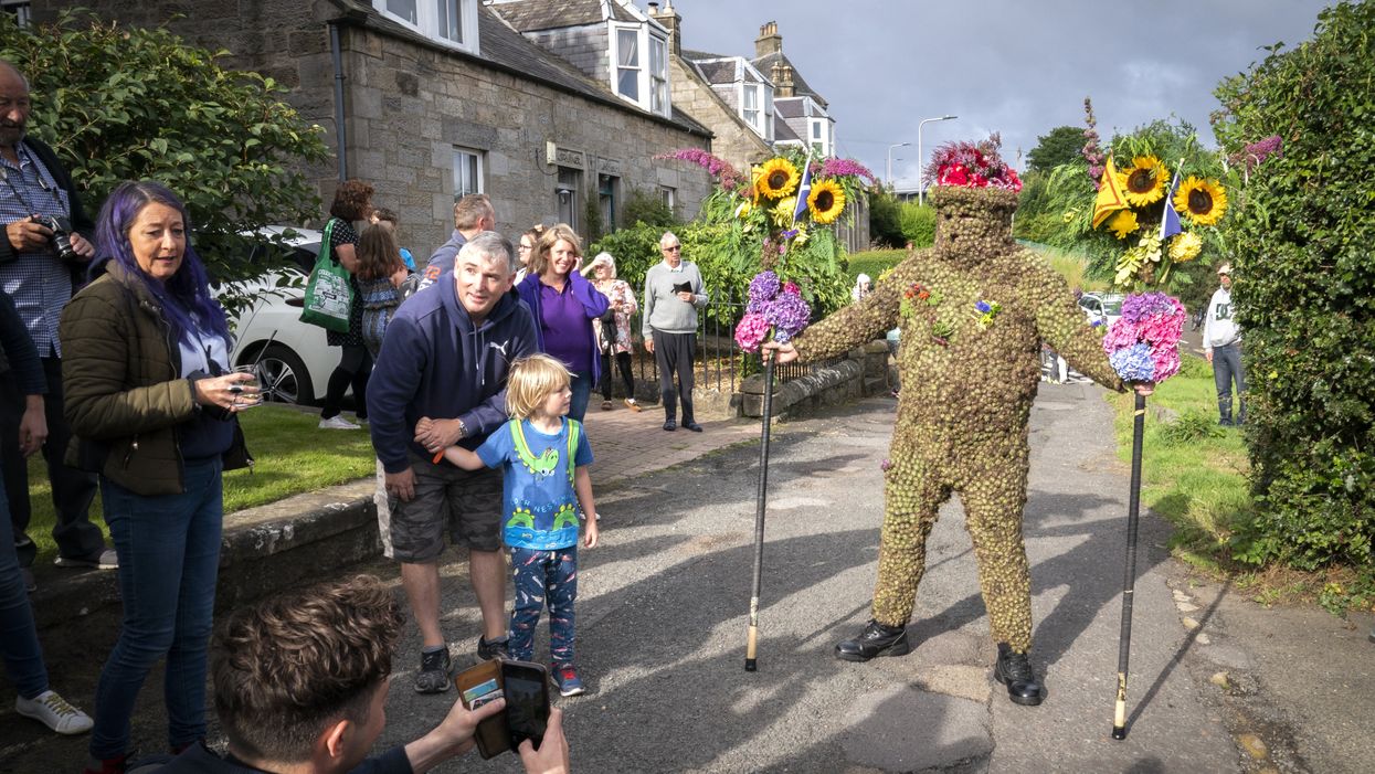 Burryman Andrew Taylor parades through the town of South Queensferry (Jane Barlow/PA)